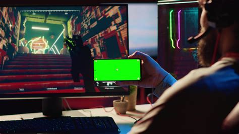 Man watching tutorial on isolated screen phone while playing first ...