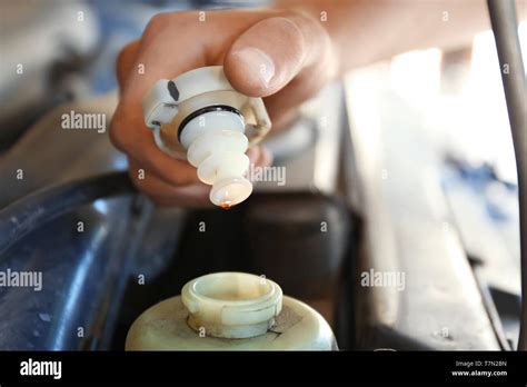 Male mechanic examining car in service center, closeup Stock Photo - Alamy
