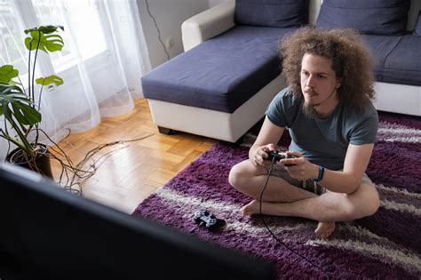 Focused Gamer Playing A Video Game Stock Photo - Download Image Now ...