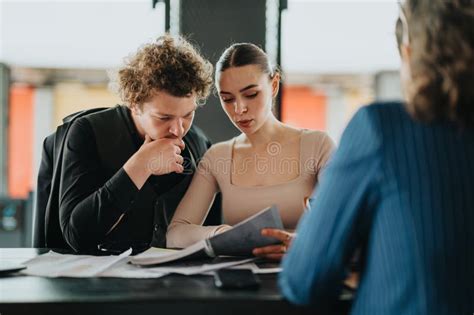 Team Collaborating on Project in Modern Office Setting with Documents ...