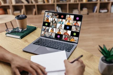 Person Taking Notes during a Video Conference Meeting in Office Stock ...