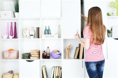 Premium Photo | Woman looking for something in closet in room with ...