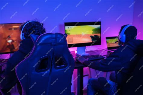 Premium Photo | Two young streamers and gamers playing video games ...