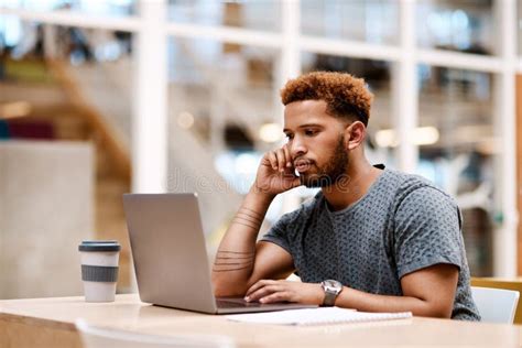 Committed To Completing His Tasks. a Young Businessman Working on a ...