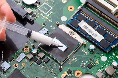 Replacing thermal paste on a laptop. Applying thermal paste to the ...
