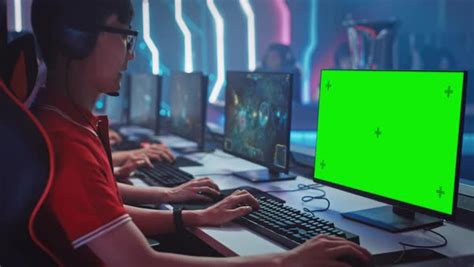 Professional Gamer Plays in a Video Game with Mock-up Green Screen ...