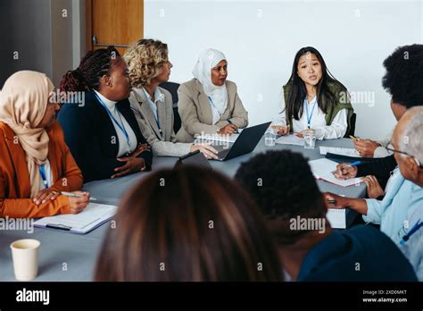 Diverse group of professionals in business meeting. Team members ...