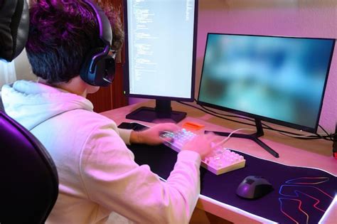 Premium Photo | Back view of concentrated young male gamer in ...