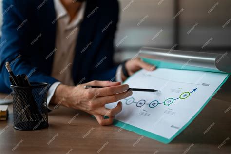 Free Photo | Person in the office analyzing and checking finance graphs