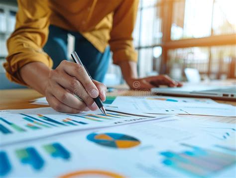 Close-up of a Person Analyzing Financial Data and Reports with Charts ...