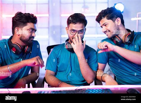 Group of professional gamers talking during video game play at esports ...