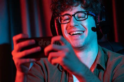 Smiling Streamer Team Playing with Esport Online on Smartphone. Gusher ...