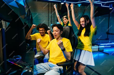 Premium Photo | Multiethnic group of young friends playing videogames