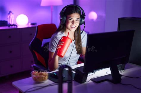 Young Beautiful Hispanic Woman Streamer Playing Video Game Drinking ...