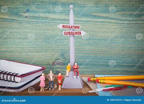 Regulations and Guidelines. Signpost on Wooden Table Stock Photo ...